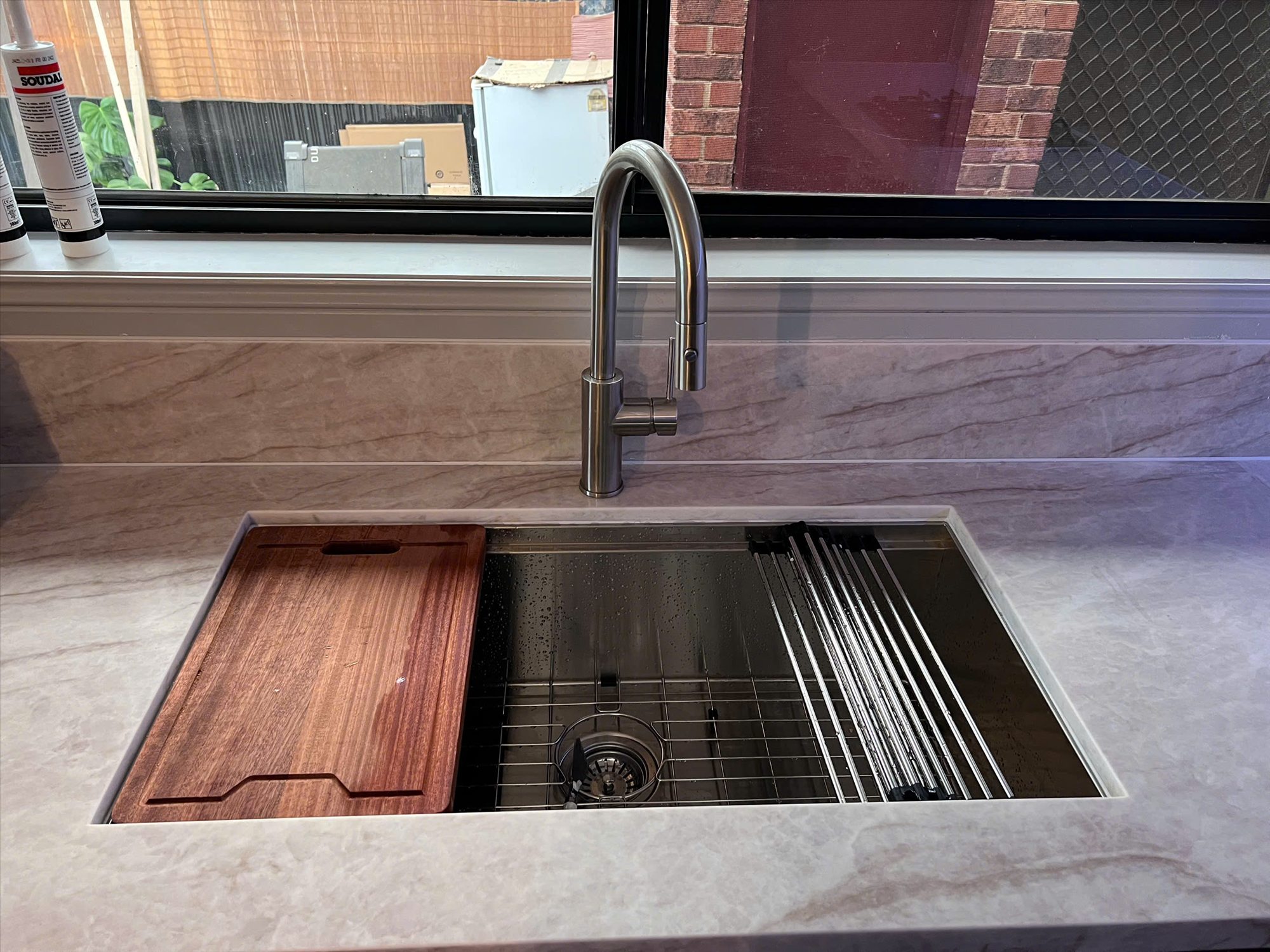 Workstation sink integrated into a custom kitchen benchtop